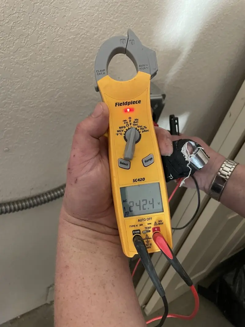 Voltage testing with clamp meter during Ceiling Fan Installation in West Point
